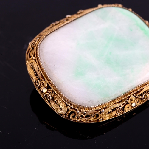 223 - A Chinese silver gilt jade panel brooch, polished tablet form with wirework filigree frame, brooch l... 