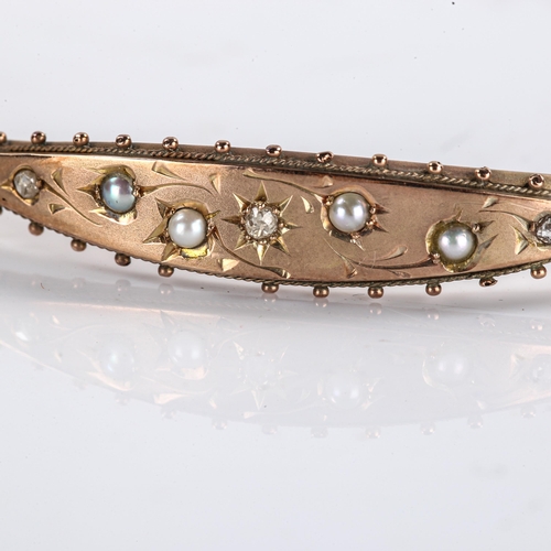 225 - An Edwardian 9ct gold split pearl and diamond hinged bracelet / bangle, engraved decoration, hallmar... 