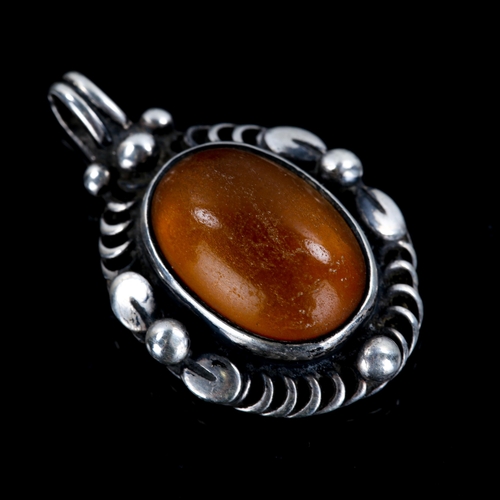 233 - GEORG JENSEN - a Vintage Danish sterling silver and amber pendant of the year 1995, and a similar pa... 