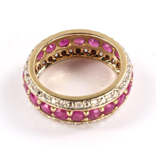 258 - A modern 9ct gold ruby and diamond full eternity band ring, set with round cut rubies and single cut... 