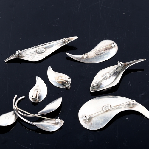 284 - 5 Danish stylised sterling silver leaf brooches, and a similar pair of clip-on earrings, makers incl... 