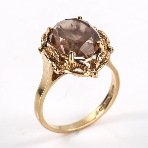 291 - A late 20th century 9ct gold smoky quartz dress ring, openwork leaf design set with oval mixed-cut q... 