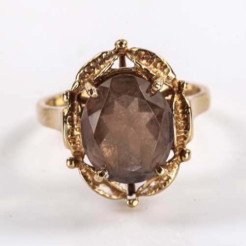 291 - A late 20th century 9ct gold smoky quartz dress ring, openwork leaf design set with oval mixed-cut q... 