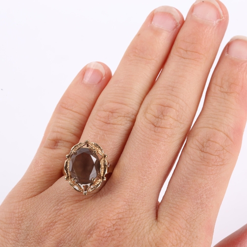 291 - A late 20th century 9ct gold smoky quartz dress ring, openwork leaf design set with oval mixed-cut q... 