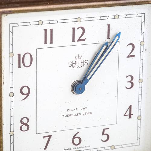 82 - SMITHS - a Vintage 8-day stirrup alarm mantel clock, white dial with Arabic numerals and swing leath... 