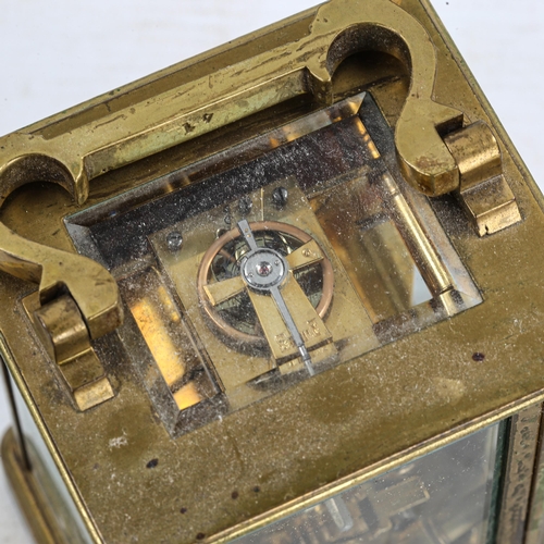 83 - A brass-cased carriage clock, white enamel dial with Roman numeral hour markers, and glass exhibitio... 