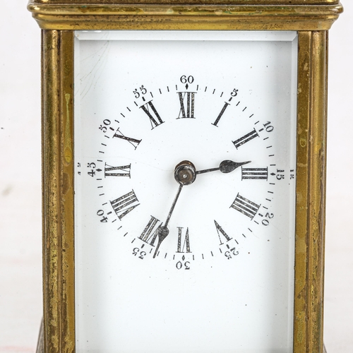 83 - A brass-cased carriage clock, white enamel dial with Roman numeral hour markers, and glass exhibitio... 