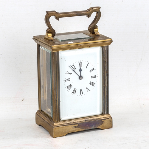 85 - A brass cased carriage clock, white enamel dial with Roman numerals and bevelled glass exhibition pl... 