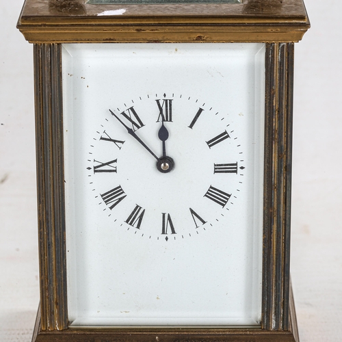 85 - A brass cased carriage clock, white enamel dial with Roman numerals and bevelled glass exhibition pl... 