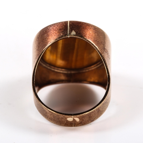 324 - A large late 20th century 9ct gold tigers eye dress ring, set with round cabochon tigers eye, maker'... 