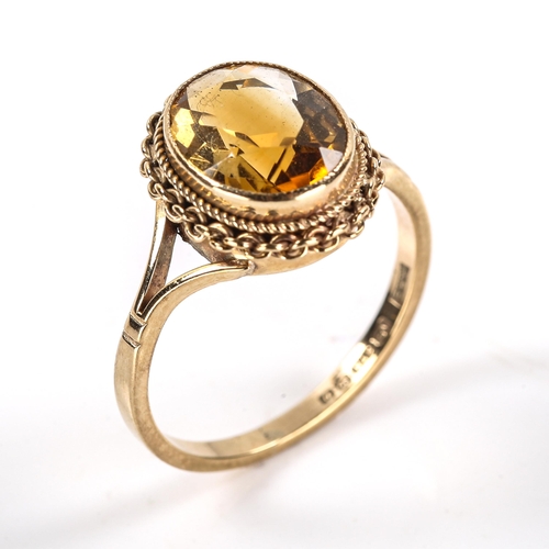 325 - A late 20th century 9ct gold citrine dress ring, set with oval mixed-cut citrine within cable and ro... 