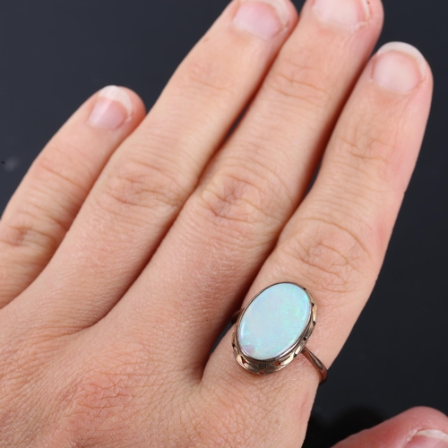 326 - A late 20th century opal dress ring, unmarked gold settings with oval thin cabochon white opal, sett... 