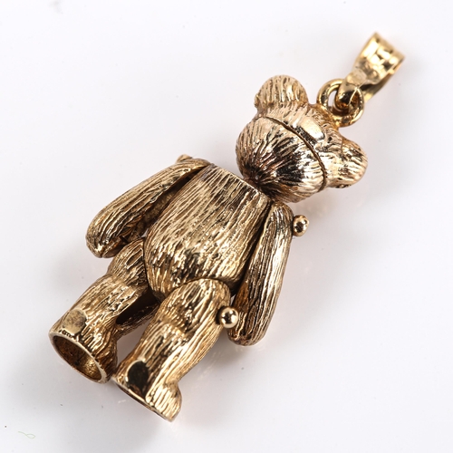 474 - A late 20th century 9ct gold cubic zirconia teddy bear charm/pendant, with articulated limbs and hea... 