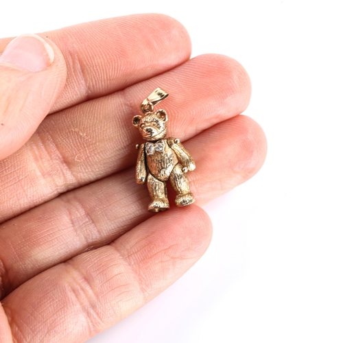 474 - A late 20th century 9ct gold cubic zirconia teddy bear charm/pendant, with articulated limbs and hea... 