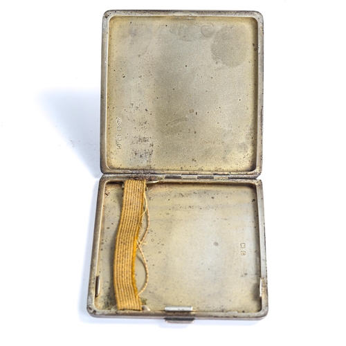 492 - An Art Deco George V square silver cigarette case, allover engine turned decoration with gilt interi... 