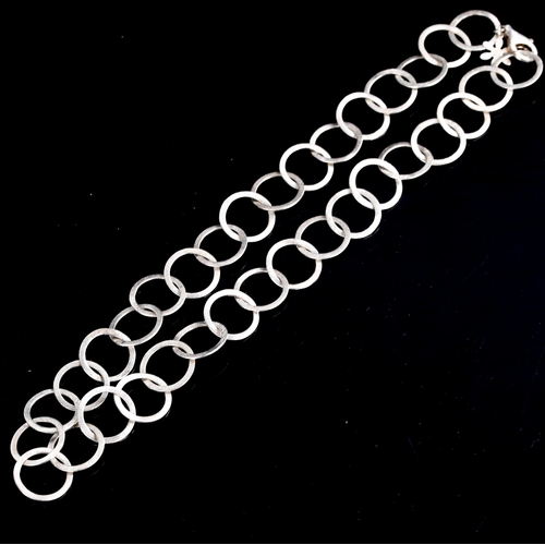 506 - STEEN F BAKER - a Danish modernist sterling silver hoop necklace, textured settings, necklace length... 