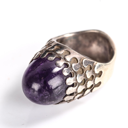 511 - A late 20th century silver and amethyst abstract ring, set with high cabochon amethyst, by Jack Spen... 