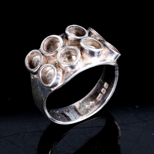 512 - A late 20th century silver abstract ring, maker's marks RW, hallmarks London 1973, setting height 12... 