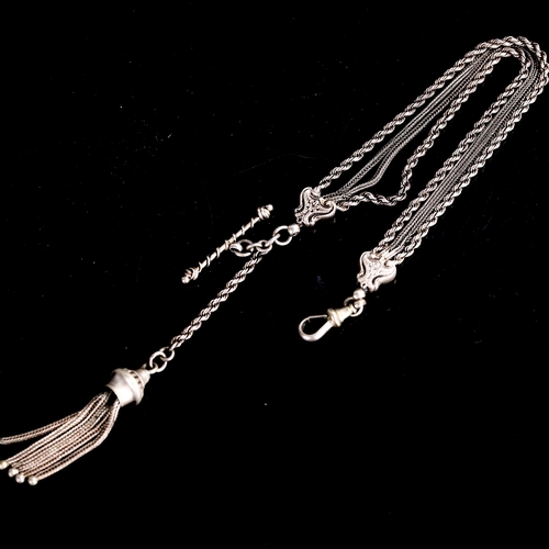 514 - An Antique Indian unmarked white metal Albertina watch chain bracelet, with tassel fob, T-bar and do... 