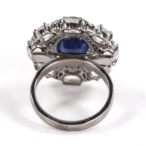 539 - A modern oxidised silver sapphire moonstone and diamond cluster ring, set with 7.40ct oval mixed-cut... 