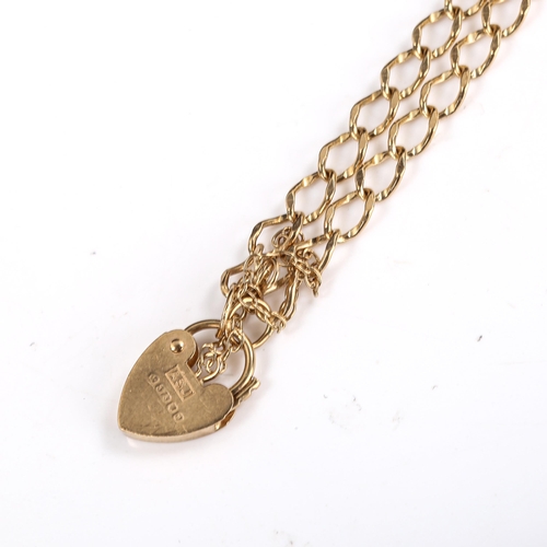 570 - A late 20th century 9ct gold heart padlock charm bracelet, hallmarks London 1988, length 16cm, 3.1g