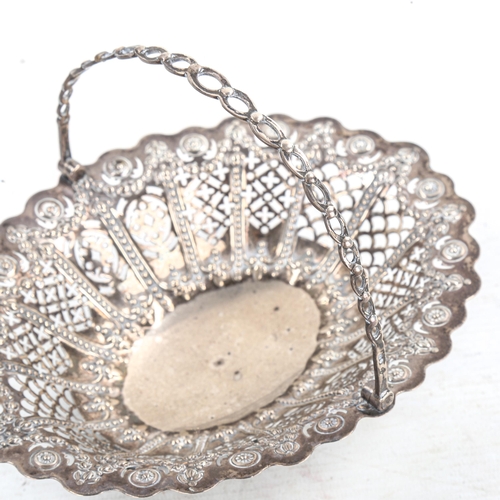 583 - A Victorian silver swing-handled basket, relief embossed Adams style swag decoration and pierced bor... 