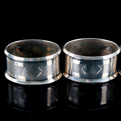 588 - A set of 4 Art Deco George V oval silver napkin rings, engine turned decoration, by Jones & Crompton... 