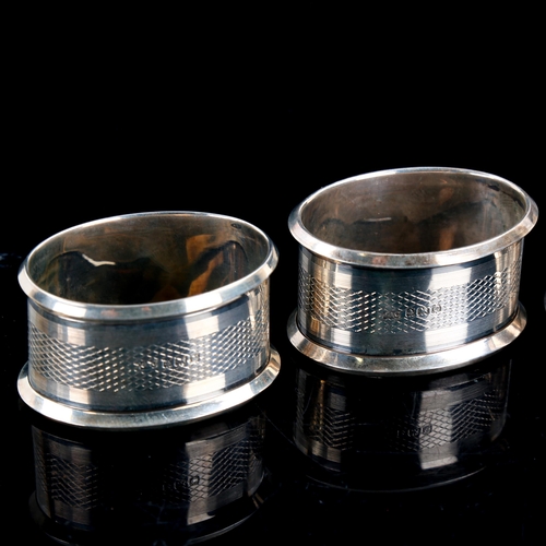 588 - A set of 4 Art Deco George V oval silver napkin rings, engine turned decoration, by Jones & Crompton... 