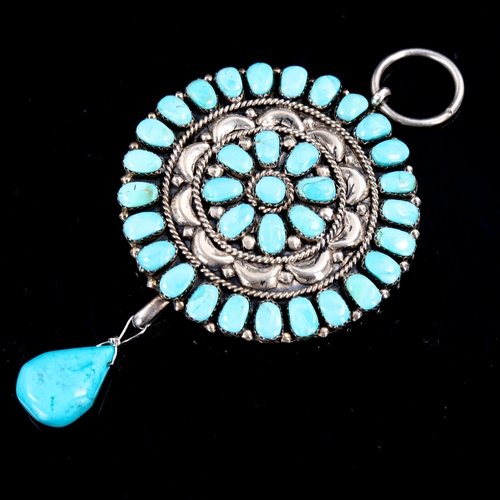 590 - A large Native American Navajo sterling silver and turquoise pendant, relief embossed decoration wit... 