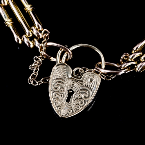 594 - A late 20th century 9ct gold gate link heart padlock charm bracelet, hallmarks London 1977, bracelet... 