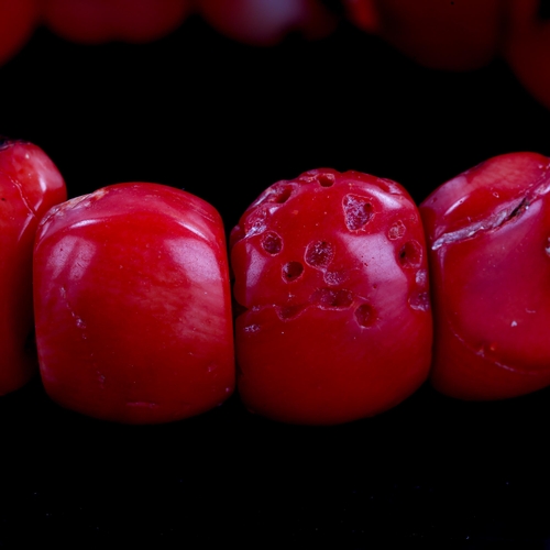 596 - A polished coral tablet bracelet, tablet lengths 18mm, bracelet length 18cm, 40.9g