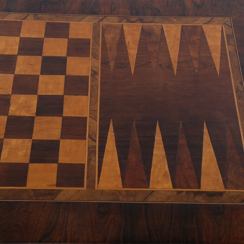 1333 - A 19th century rosewood games-top stretcher table, the top inlaid with chess board and back gammon b... 