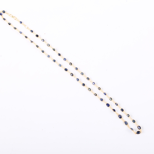 385 - A modern handmade 14ct gold Ceylon sapphire line necklace, set with graduated oval mixed cut sapphir... 