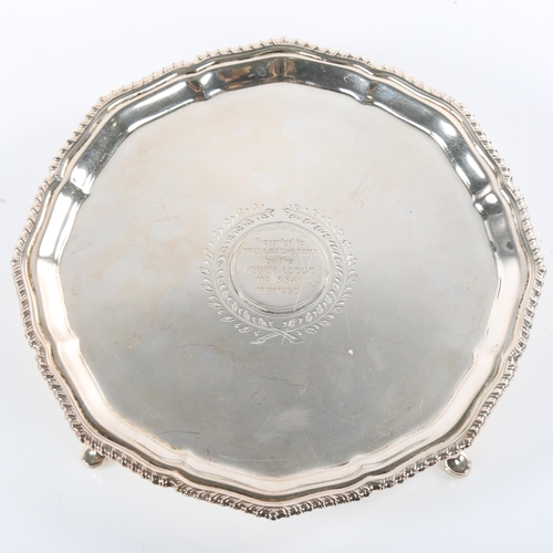 670 - A George V silver salver, circular form with gadrooned rim and four hoof feet, masonic presentation ... 