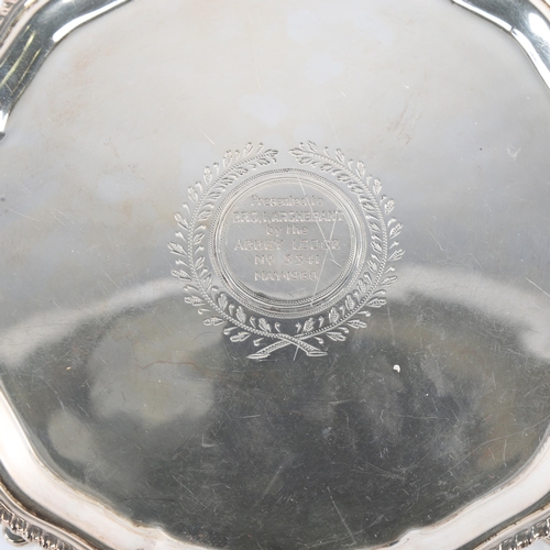 670 - A George V silver salver, circular form with gadrooned rim and four hoof feet, masonic presentation ... 