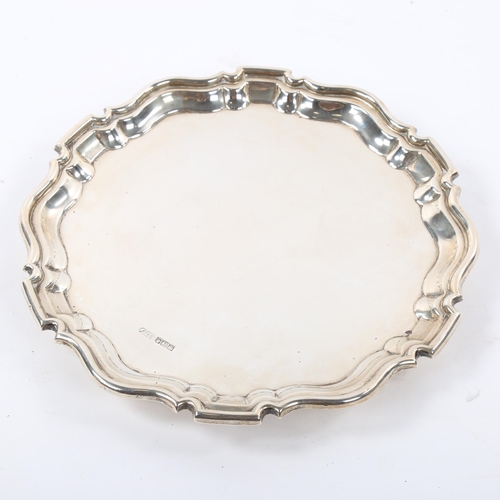 672 - An Edwardian silver salver, scalloped rim with 3 scrolled foliate feet, maker's marks J T & Co, hall... 