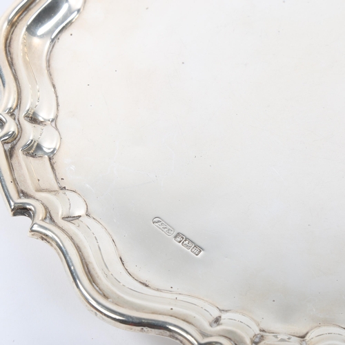 672 - An Edwardian silver salver, scalloped rim with 3 scrolled foliate feet, maker's marks J T & Co, hall... 