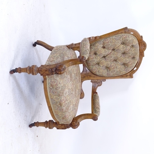 2086 - A Victorian carved walnut-framed open armchair, with button-back upholstery