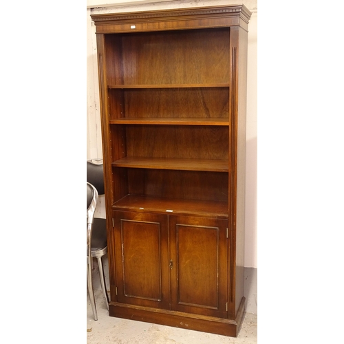 2555 - A reproduction mahogany open bookcase, with 3 adjustable shelves and cupboards under, W85cm, H182cm,... 