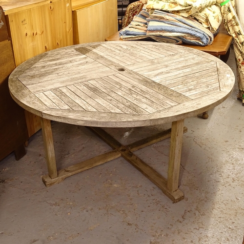 2565 - A large weathered circular teak garden table, W160cm, H76cm