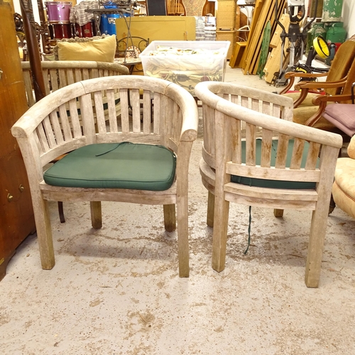 2566 - A pair of weathered teak bow-arm garden chairs, and cushions