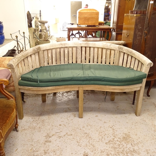 2567 - A weathered teak banana garden bench, and cushions