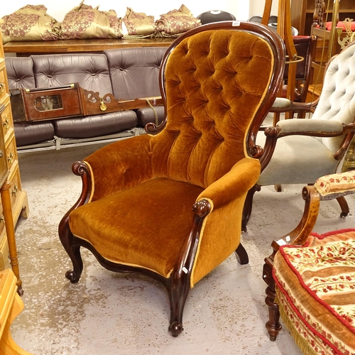 2576 - A Victorian mahogany-framed spoon-back armchair, with buttoned upholstery