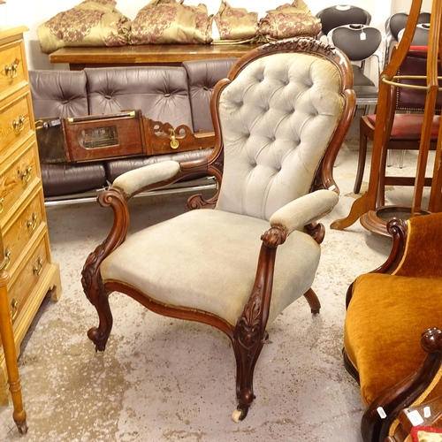 2577 - A Victorian walnut-framed open armchair, with button-back upholstery