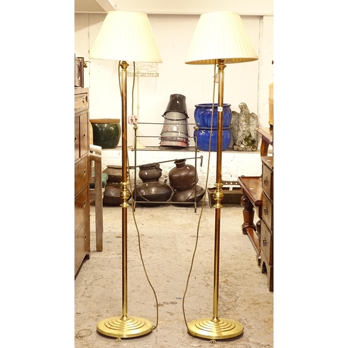 2579 - A pair of brass-effect standard lamps and shades, height to top of shade 156cm