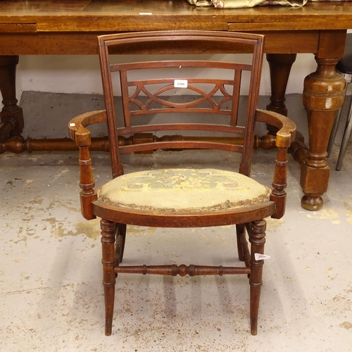 2586 - A Victorian bow-arm armchair of small size, with needlepoint upholstery