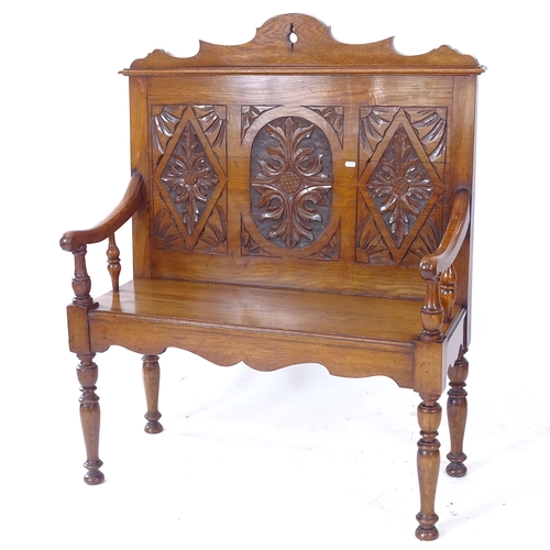 2067 - A small size oak settle with acanthus leaf carved panelled back, on turned legs, W95cm, H114cm, D39c... 