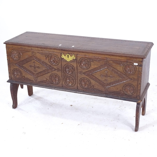 2088 - An 18th century and later 6-plank coffer, with relief carved panelled front, on shaped later legs, W... 