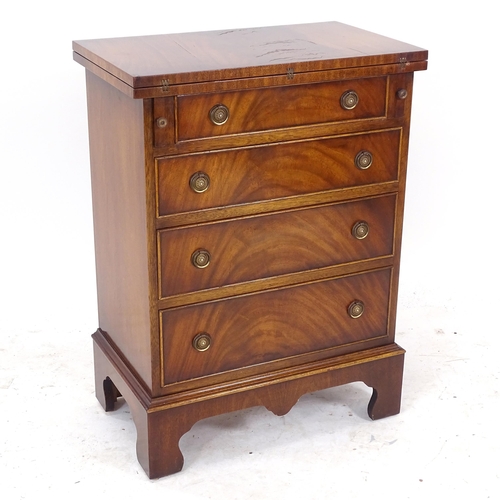 2093 - A reproduction mahogany bachelor's chest, with fold over top, 4 graduated drawers under, on bracket ... 