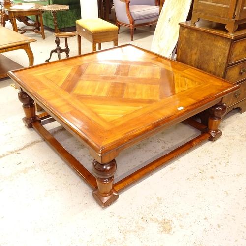 2600 - A large cherrywood effect square coffee table, with a parquetry top, on baluster turned legs, W120cm... 